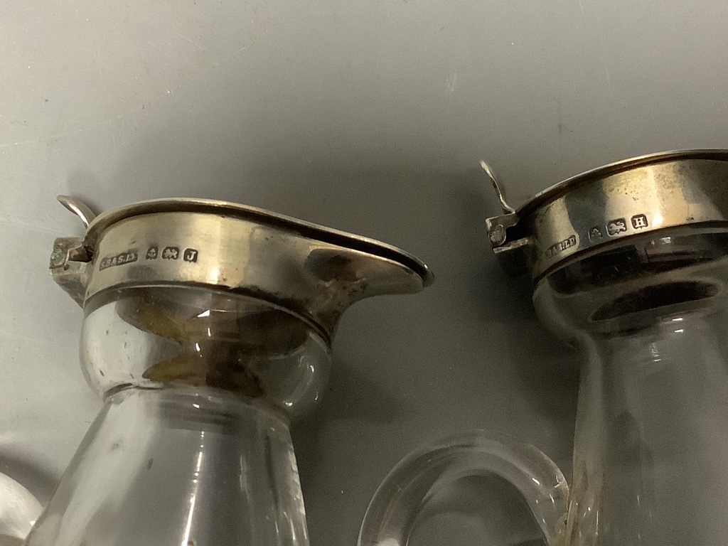 A pair of George V silver mounted glass whisky tot jugs, S. Blanckensee & Sons Ltd, Birmingham, 1932/3, height 10.3cm.